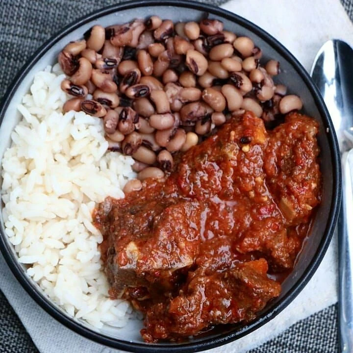 White rice and beans served with red stew